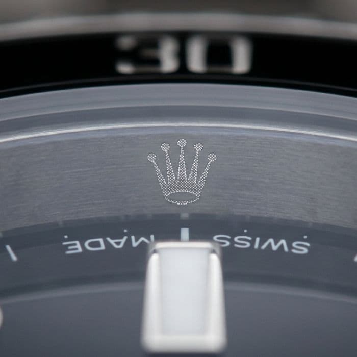 Detailed view of Rolex Submariner laser-etched crown on crystal